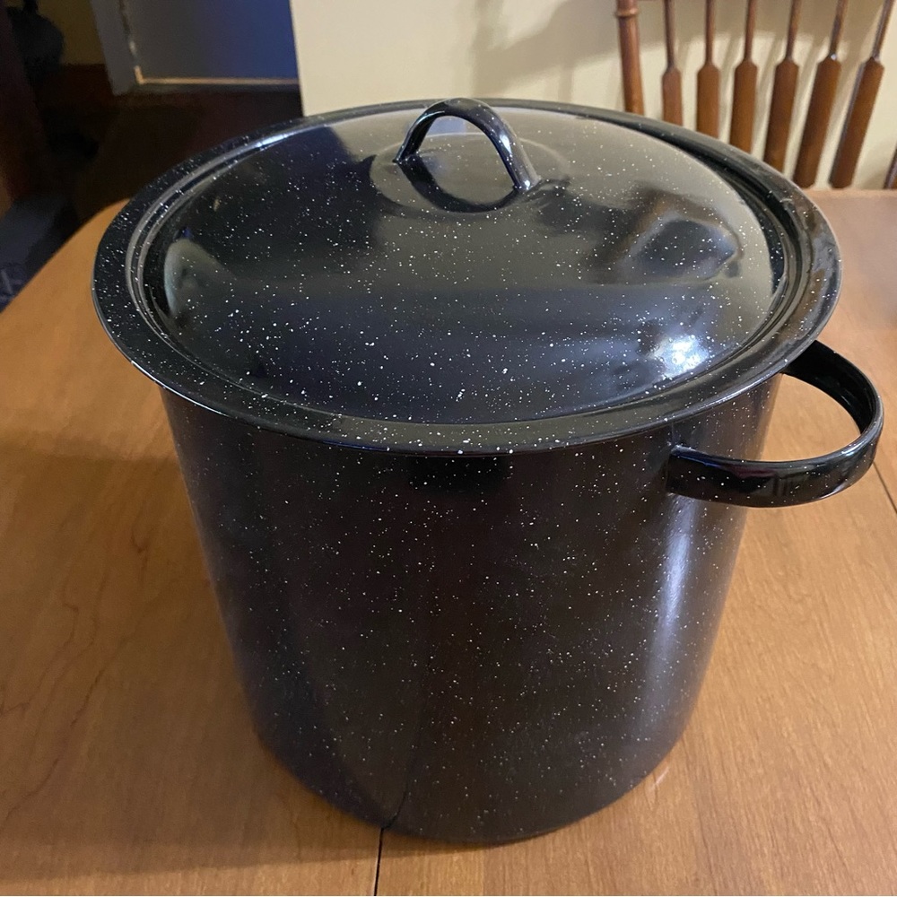 Speckled black enamelware stockpot and stainless steel strainer